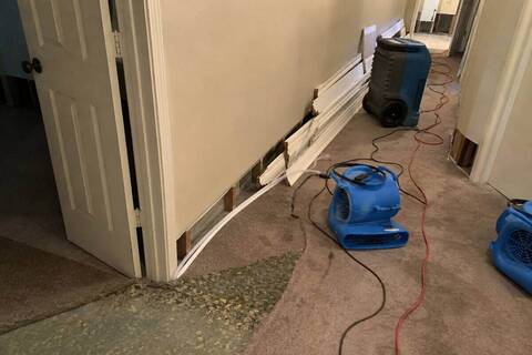 Air movers and a dehumidifier running during a structural dry-out