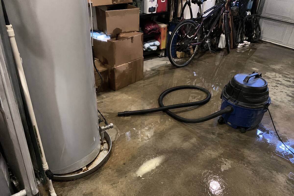 Water spreading across a garage floor from a failed water heater